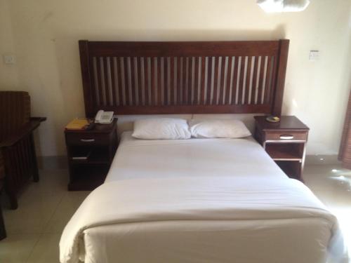 a bedroom with a large bed with two night stands at Kadoma Hotel & Conference Centre in Katoma