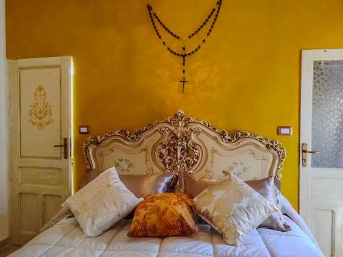 a bedroom with a white bed with pillows on it at Casa Tre in Mussomeli