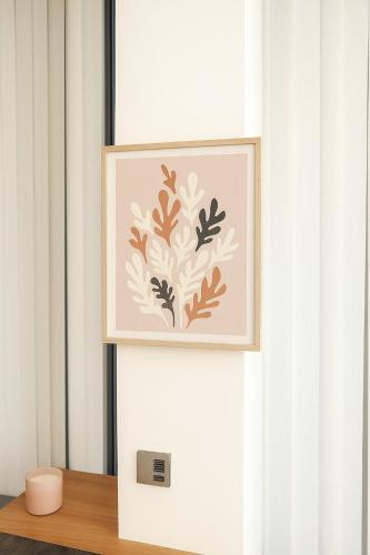 a picture of a flower on a wall next to a window at Large Studio at ExCeL London-Pets Ok-WiFi-Self CheckIn in London