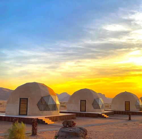 a group of three domes in the desert at sunset at Wadi Rum Abu Khaled in Wadi Rum