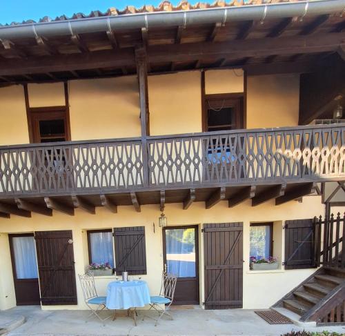 a balcony of a building with a table and chairs at Le Clairat in Saint-Michel-Saint-Jaymes