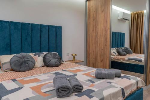 1 Schlafzimmer mit 2 Betten mit Kissen und einem Spiegel in der Unterkunft Luxury & Modern Apartment - Rowing Canal Plovdiv in Plowdiw