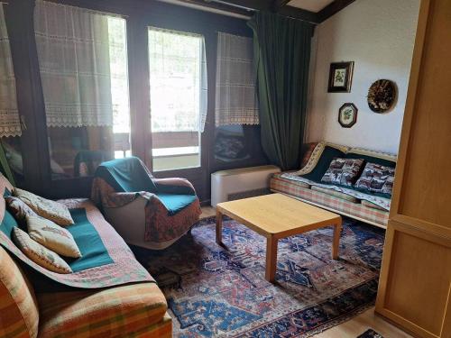 a living room with a couch and a table at Casa Lolli in Madonna di Campiglio