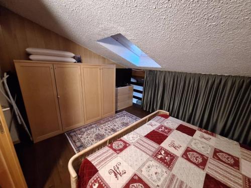 a bedroom with a bed with a quilt on it at Casa Lolli in Madonna di Campiglio