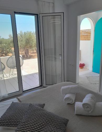 a room with towels on the floor next to a door at Sunsets and Olive Trees in Messini