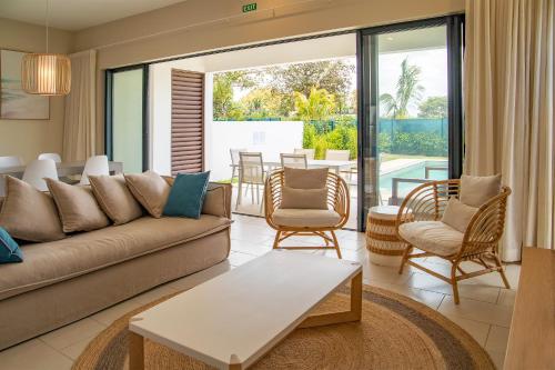 a living room with a couch and chairs at Serenity Pool Villa at Azuri in Roches Noires