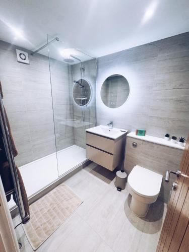 a bathroom with a shower and a toilet and a sink at Little Dunton Lodges 1 in Little Burstead
