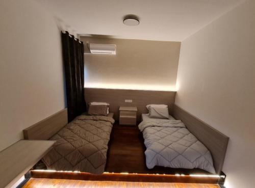 a small room with two beds in it at Lucky 7 Homestay - Utama Court in Sandakan