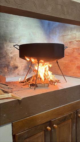 a grill with a fire inside of it at Apart La Ideal in Villa Cura Brochero