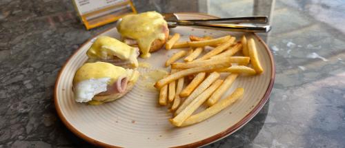 a plate of food with a sandwich and french fries at MoonBasa Boutique Hotel and Spa Infopark , Kakkanad in Cochin
