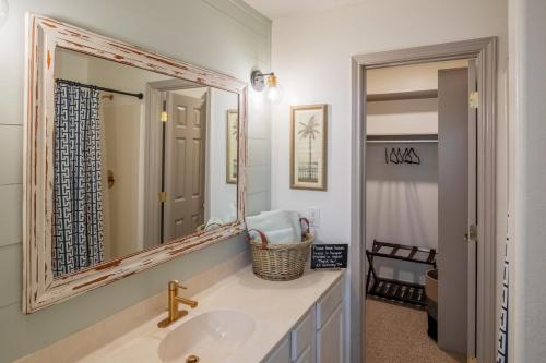 a bathroom with a sink and a mirror at AK Getaway Too ,where the waves the shore and worries melt away. in Port Aransas