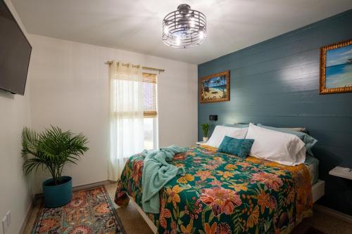 a bedroom with a bed and a potted plant at AK Getaway Too ,where the waves the shore and worries melt away. in Port Aransas
