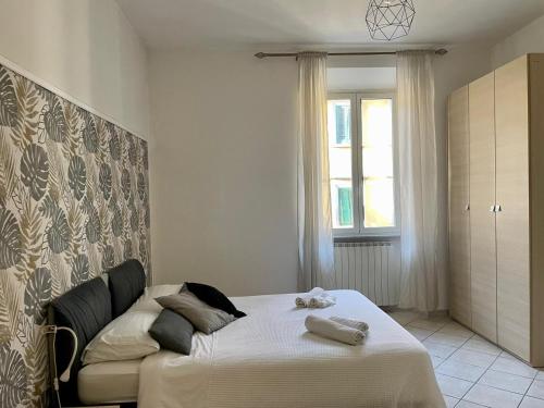 a bedroom with a bed and a window at Jacuzzi Suite in Livorno