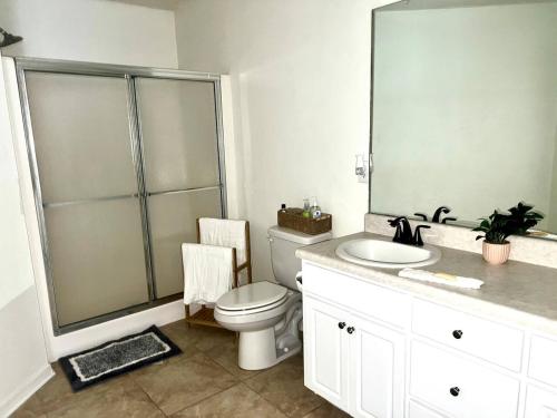 a bathroom with a toilet and a sink and a shower at Cozy Private Room in Milton near Beaches in Milton