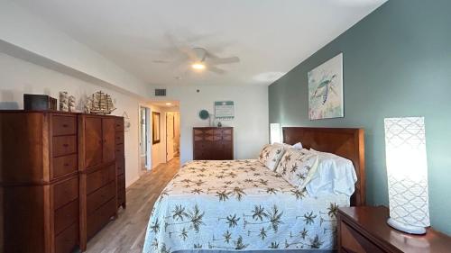 a bedroom with a bed and a dresser at Seashell Escape in New Smyrna Beach