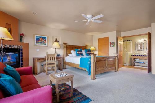 a bedroom with a bed and a living room at Adobe Hacienda- Sedona Suite in Oak Creek