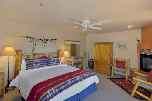 a bedroom with a bed and a ceiling fan at Adobe Hacienda - Anasazi Suite in Oak Creek