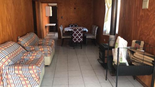 a living room with couches and a dining room table at Cabañas Mami Kiki in Panguipulli