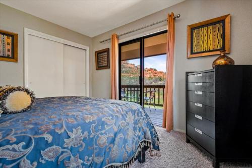 ein Schlafzimmer mit einem Bett und einem Fenster mit Aussicht in der Unterkunft Toroweap - Adobe Village condo - 2 bedroom in Oak Creek