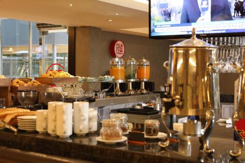 una línea de buffet con comida y TV en un restaurante en Casa Andina Select Chiclayo, en Chiclayo