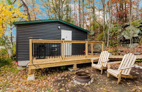 a deck with two chairs and a dog house at Studio Cottage in Pine Lake #6 in Gravenhurst