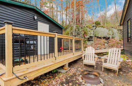two chairs sitting on a deck next to a house at Studio Cottage in Pine Lake #6 in Gravenhurst