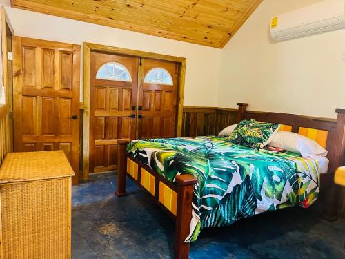 a bedroom with a bed and a wooden ceiling at Howler Landing Vacation Rental in Bermudian Landing