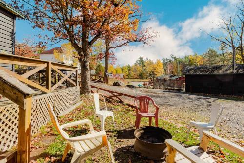 a group of chairs sitting around a fire pit at 3-Bedroom Cottage #7 - Austrian Pine in Gravenhurst