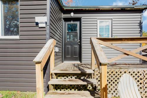 a wooden ramp leading to a house with a door at 3-Bedroom Cottage #7 - Austrian Pine in Gravenhurst