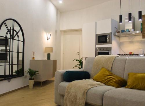 un soggiorno con divano e cucina di Garden Suite Milano - Vero Gioiello con Giardino a 5 minuti da Mediaset e San Raffaele a Cologno Monzese