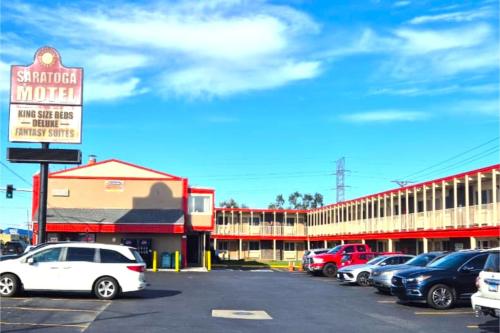 a parking lot with cars parked in front of a motel at Saratoga Motel By Capital O Near Midway Airport Chicago IL in Burbank