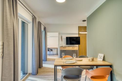 a dining room with a table and chairs at Sattler Living Apartments in Ebbs