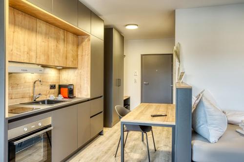 a small kitchen with a table and a bed at Sattler Living Apartments in Ebbs