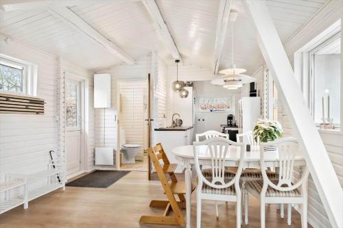 a white dining room with a table and chairs at SJ314-Haderslev-Kelstrup-Norreskov-42 in Kelstrup Strand