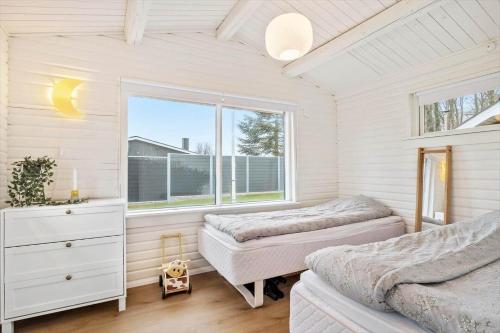 a bedroom with two beds and a window at SJ314-Haderslev-Kelstrup-Norreskov-42 in Kelstrup Strand