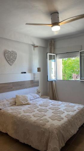 a bedroom with a bed and a ceiling fan at Masia Bernat in Tortosa