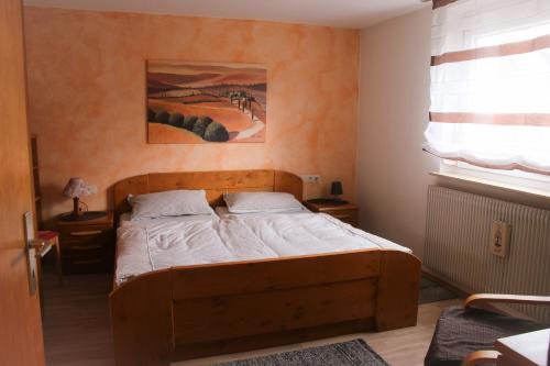 a bedroom with a wooden bed in a room at Ferienwohnung Talblick in Meßstetten