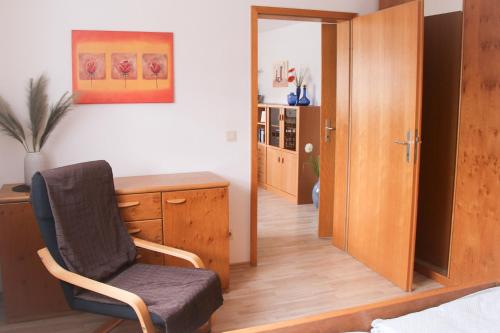 a bedroom with a desk and a chair in a room at Ferienwohnung Talblick in Meßstetten