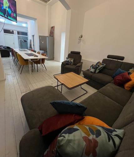 a living room with two couches and a table at Alter Bahnhof Schwaan - Monteurswohnungen in Schwaan