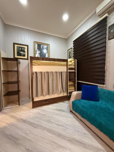 a bedroom with a bed and a large window at Caspian Hostel in Baku