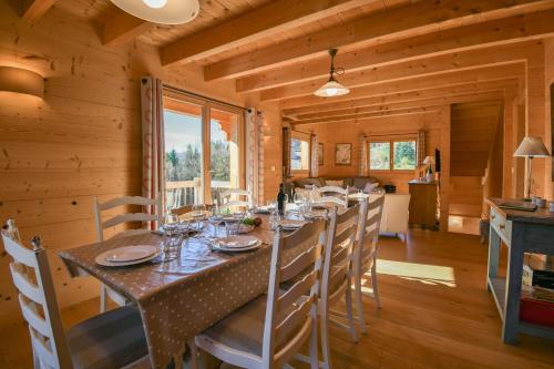 Chalet - Arosa في لو غراند بورناند: غرفة طعام بها طاولة طويلة في كوخ