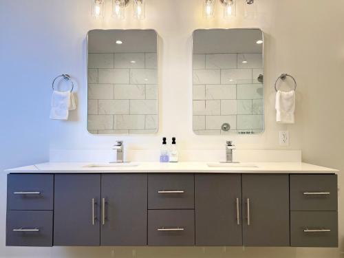 a bathroom with two sinks and a mirror at The Benjamin Hotel in Watkins Glen