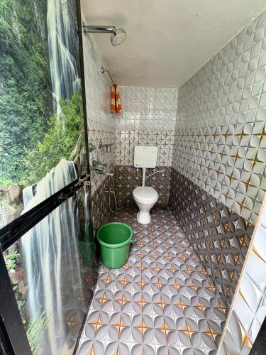 a bathroom with a shower with a toilet in it at RadhaKrishna Stay IN in Arambol