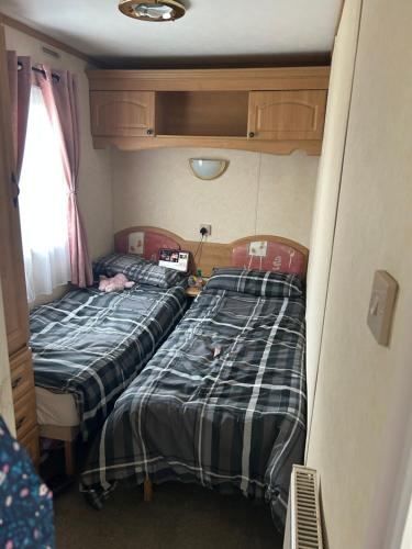 two twin beds in a small room in a train at My happy place in Greencastle