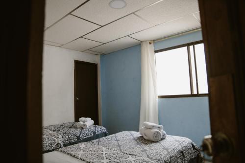 a bedroom with two beds with stuffed animals on them at Casa de Alexis in Puerto Baquerizo Moreno