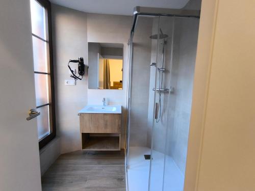 a bathroom with a sink and a shower at HeyWelcome Valladolid Centro in Valladolid