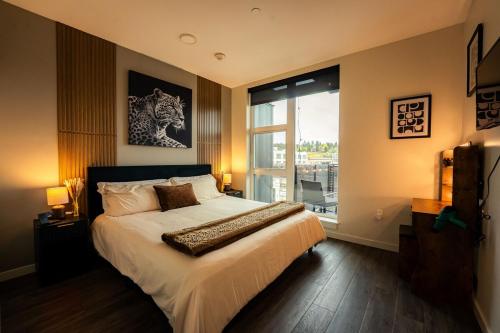 a bedroom with a large bed and a large window at Heart of Downtown Apt with City View, Walkable to HotSpots in Spokane