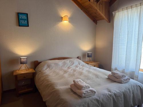 ein Schlafzimmer mit einem Bett mit Handtüchern darauf in der Unterkunft Paimun 2 - Andarlibre in San Martín de los Andes