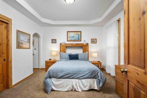 a bedroom with a large bed and two night stands at Twin Rocks Hideaway in Rockaway Beach