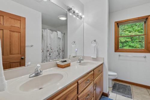 a bathroom with a sink and a toilet and a mirror at Peaceful View in Linville Falls